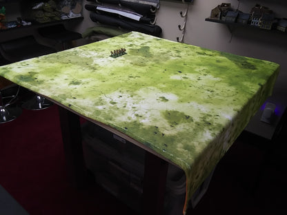 a table with a green cloth on top of it